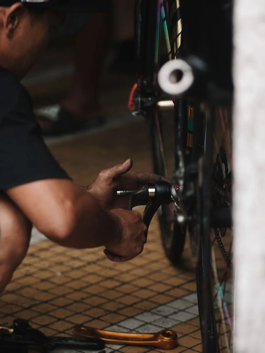 Bicycle mechanic servicing a bike in a repair workshop
